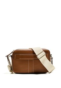 Brown leather crossbody bag with white stitching, rectangular shape, zip closure, and a beige adjustable strap. Features two front pockets.