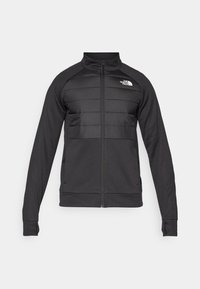 Schwarze Jacke mit einem Reißverschluss vorne, gepolstertem oberen Brust- und Schulterbereich, langen Ärmeln und einem Stehkragen. Logo auf der oberen linken Seite.