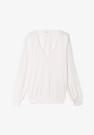 Haut blanc à manches longues avec un col en V et des détails en dentelle le long des épaules. Présente des poignets élastiques et une coupe décontractée. Texture de tissu douce.