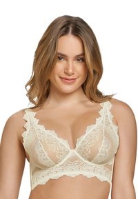 Kant bralette in zacht crème, met geschulpte randen, doorzichtige stof en bloemenpatronen. Verstelbare bandjes met ondersteuning van beugel.