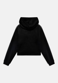 Black cropped hoodie in soft fabric with a hood, featuring decorative studs along the side seams and ribbed cuffs.