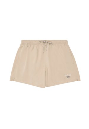 Bañador corto para hombre beige con cintura elástica, cordón frontal, bolsillos laterales, pequeño logo de la marca en la pierna izquierda y pequeñas aberturas laterales.