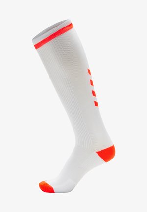 Calcetines de compresión en tela blanca con vivos de color naranja brillante en la parte superior y en la punta. Cuenta con una textura ribeteada y un patrón en los laterales.