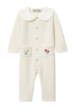 Barboteuse tricot crème pour bébé avec manches longues, bords festonnés, fermeture à boutons sur le devant, col Claudine blanc et petite broderie florale sur les poches avant.