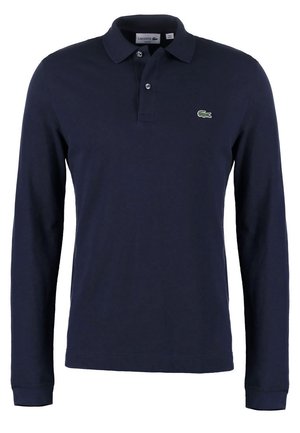Temno_modra polo majica s dolgimi rokavi, izdelana iz bombaža, z klasičnim ovratnikom, dvema gumboma in zelenim logotipom Lacoste na prsih.