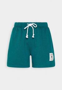 Tyrkysové bavlněné šortky s elastickým pasem a bílým stahovacím šňůrkou, krátkou délkou a nášivkou s logem na levé straně.