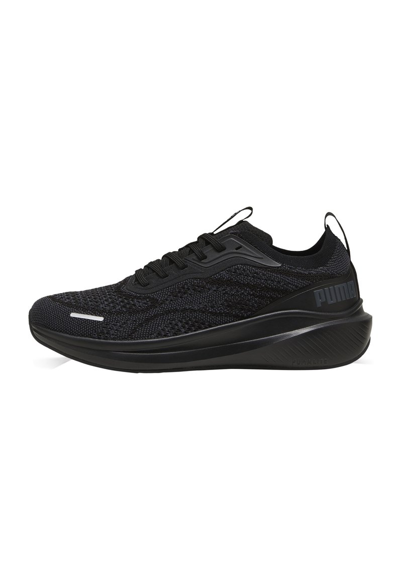 Scarpe sportive nere con tomaia in rete intrecciata, suola arrotondata, minimi accenti bianchi e logo sul tallone. Design leggero e traspirante.