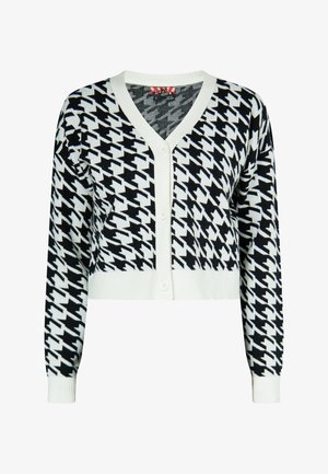 Afskåret cardigan i houndstooth mønster, sort og hvid. Har en dyb V-hals, knaplukning foran samt ribkantede ærmer og kant.