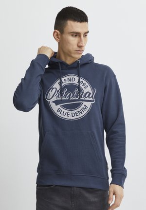 Navy blue hoodie made of cotton blend; features a large white graphic print with text “Original” and kangaroo pocket. Drawstring hood included.
