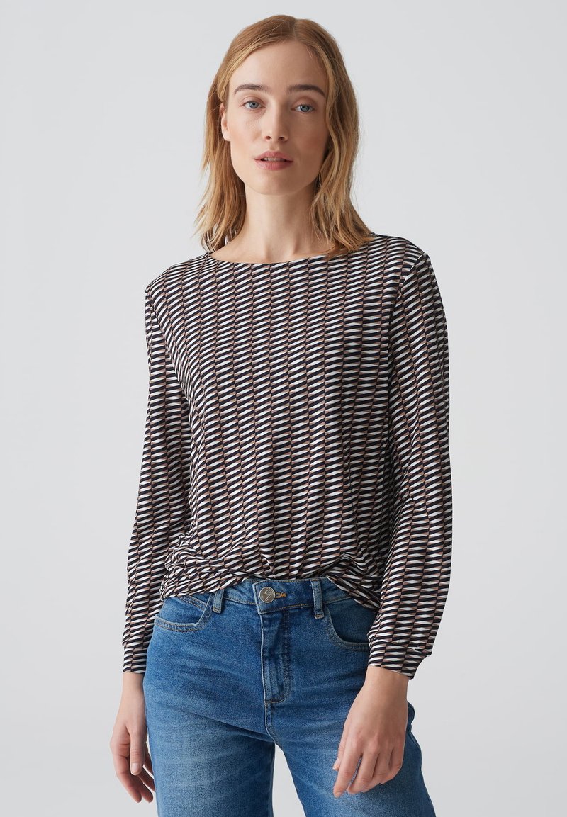 Langdurig mouwen met een patroon in zwart, wit en bruin, met een ronde halslijn en een losse pasvorm. Gekocht met blauwe denim jeans.