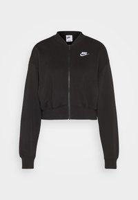 Zkrácená černá mikina s předním zipem, žebrovanými manžetami a bílým logem Nike na levém prsu. Měkká tkanina s texturovaným povrchem.