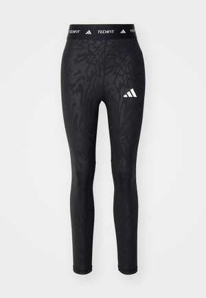 Svarta leggings med ett texturerat mönster, som har en vit Adidas-logotyp och en TECHFIT midja. Tillverkade av stretchigt material för komfort.