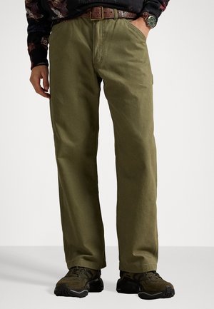 Olive green cotton pants with a straight-leg design, featuring a belt and side pockets, paired with dark athletic shoes.