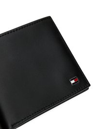 Black leather wallet with smooth texture, folded design, and a small logo featuring red, white, and blue colors on the front.