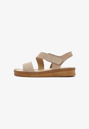 Beige suede sandal with two wide straps, adjustable Velcro closure, and a cushioned sole. Features a textured light brown midsole.