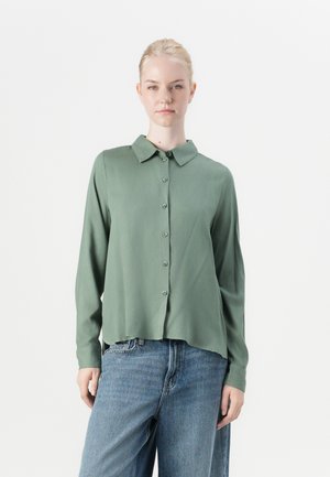 Green, long-sleeved button-up shirt made of soft fabric with a collared neckline, featuring a slightly curved hem and a relaxed fit.