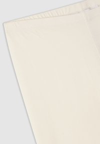 Jasnobeżowe legginsy o gładkiej, elastycznej strukturze i elastycznym pasie, z prostym, bezszwowym wzorem, idealne do codziennego noszenia.