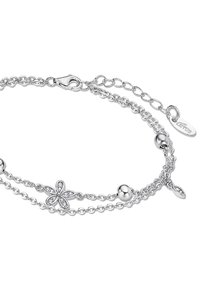 Silver bracelet with two chain strands, featuring a floral design with sparkling accents and round beads, secured with a lobster clasp.