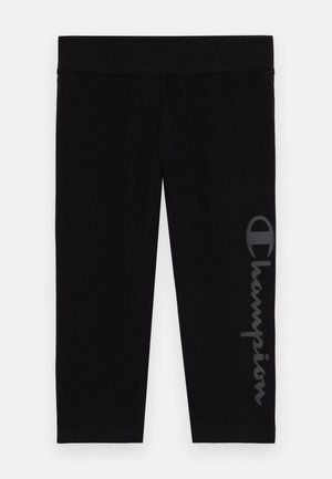 Crne tajice od mekog, rastezljivog materijala s elastičnim pojasom. Sadrže reflektirajući Champion logo duž lijeve noge.