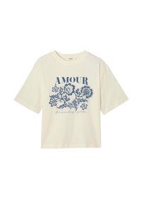 T-shirt crème à manches courtes avec un motif floral bleu "AMOUR" et un texte d'accompagnement. Fabriqué en tissu doux, style ample.