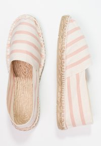 Canvas espadrilles with pink and cream stripes, jute soles, and stitched edging. Open design with rounded toe and flat heel.