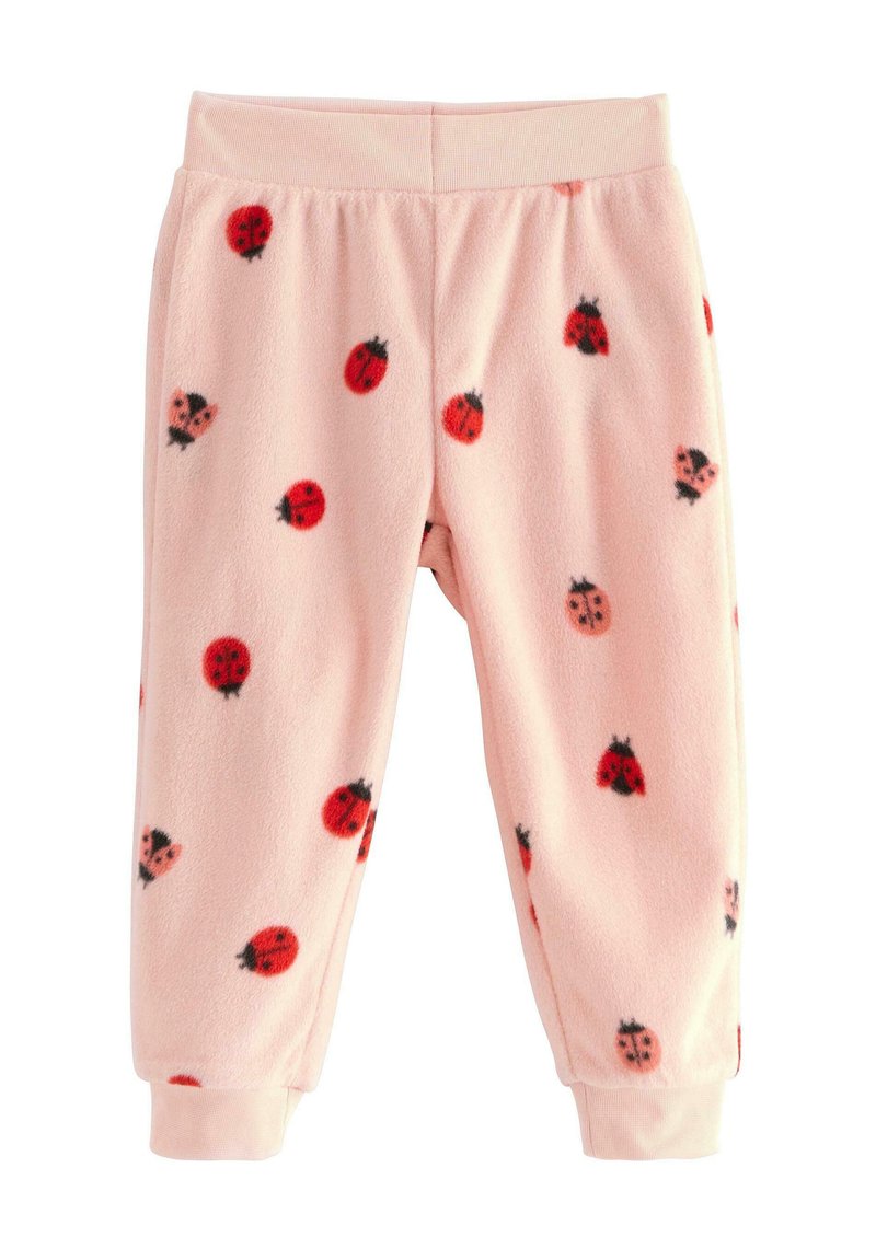 Fleece pyjamasbukser i lyserød, med et mønster af røde marihøner, sorte detaljer og elastisk talje med manchetter.