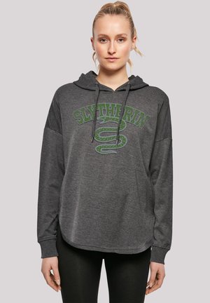 Grå hettegenser med Slytherin-logo, som har et slangegrafikk. Materialet virker mykt, med en løs passform og design med kengurulomme.