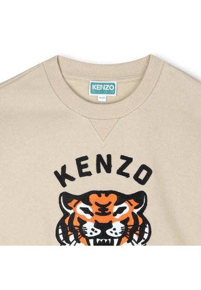 Sweatshirt beige avec un graphique de tigre brodé orange et noir, avec le texte "KENZO" en noir au-dessus, et un col en rib à détails.