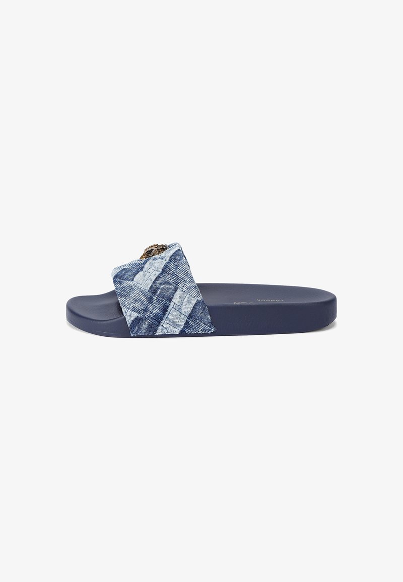Blue slide sandal featuring a denim-patterned fabric strap and a solid navy molded sole. Decorative details include hardware on the strap.