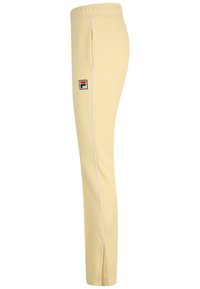 Lichtgele joggingsbroek gemaakt van een gladde stof met een witte zijstreep en een geborduurd logo op de bovenkant van de linkerdij.