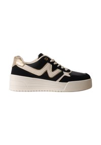 Baskets basses noir et blanc avec lacets blancs, semelle blanche épaisse, détail doré au talon et motif zigzag blanc sur le côté.