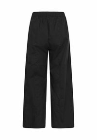 Pantalon noir à jambes larges avec taille élastiquée, coupe droite et détails subtils des coutures, vu de dos sur fond blanc.