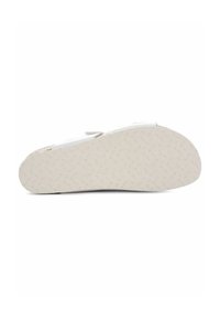 Witte sneakerzool met een gestructureerd rubberen patroon. Heeft een ronde vorm en een lichte kromming bij de teen voor verbeterde grip en comfort.
