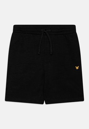 Bermudas negras de tejido ligero con cintura elástica y cordón ajustable. Presentan un pequeño logo dorado en la parte frontal.