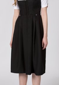Black dress with a fitted bodice and pleated skirt. Features a zip closure and decorative buttons, made from textured fabric.