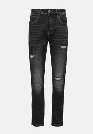 Zwarte denim jeans met een slim fit, voorzien van versleten scheuren, subtiele vervaging en contrasterende stiksels. Standaard knoopsluiting en vijf zakken.