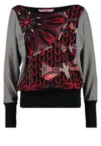 Sweat-shirt avec un motif floral noir sur le devant, manches grises et poignets noirs. Présente des couleurs vives et des motifs élaborés.