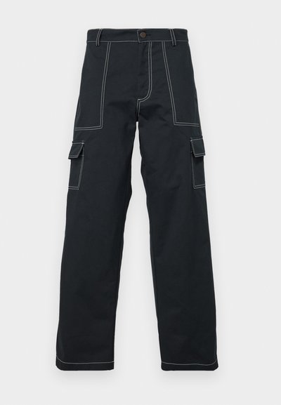 Black cargo pants with white stitching, featuring a relaxed fit, multiple side pockets, and a button closure at the waistband.