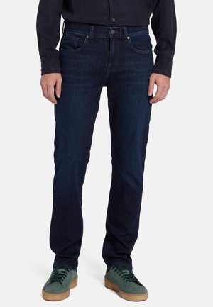 Mørkeblå denimjeans med lige snit, med klassisk fem-lomme design og metalknaplukning. Blød tekstur, alsidig pasform.