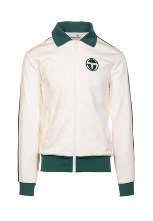 Veste blanche zippée avec col et poignets verts, arborant un logo sur la poitrine gauche et des bandes noires sur les côtés le long des manches.