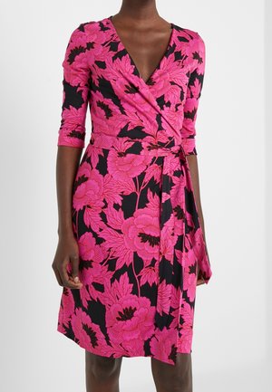 Wrap dress featuring a deep V-neck, three-quarter sleeves, and a vibrant pink floral print on a black background. Made of soft fabric.
