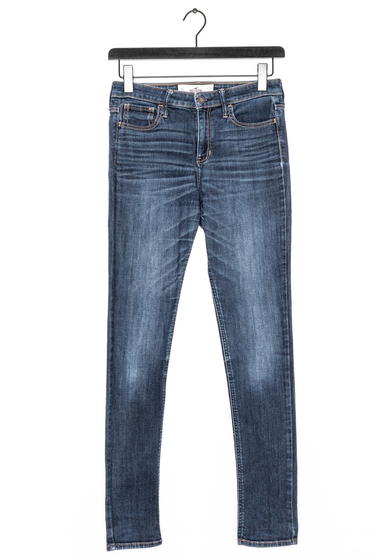 Dark blue denim jeans with a slim fit, five-pocket design, and contrasting stitching. Fabric shows a smooth texture with slight fading.