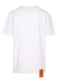 Balts kokvilnas T-krekls ar brīvu piegriezumu, apaļu kakla izgriezumu, īsām piedurknēm un oranžu zīmola etiķeti kreisajā pusē netālu no apakšmala.