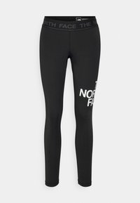 Černé legíny vyrobené z elastického materiálu. Mají široký pás s logem "THE NORTH FACE" a velké bílé logo na levé nohavici.