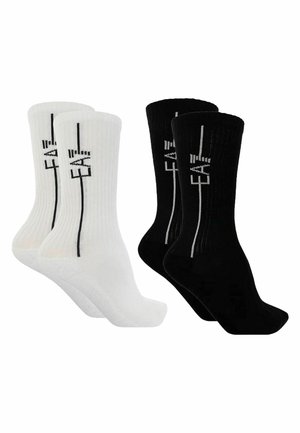 Set of four crew socks in white and black, ribbed texture, featuring contrasting vertical text design on each sock.