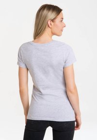 Gray short-sleeve t-shirt made of soft fabric. Features a round neckline and a fitted design, visible stitching along the seams.