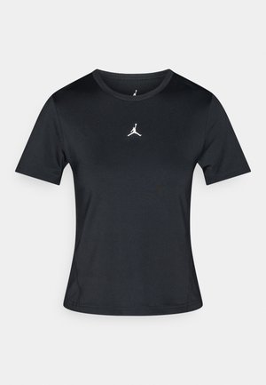 T-shirt de sport noir à manches courtes en tissu lisse, avec un logo Jordan blanc au centre de la poitrine. Design à col rond.