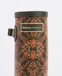 Green patterned rubber boot featuring embossed floral design in orange, with a black strap and gold logo label for Barbour FARM RIO.