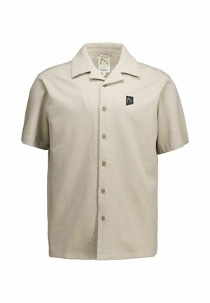 Bézs színű, rövid ujjú, gombos ing gallérral és egy kis fekete logófolttal a bal mellrészen.