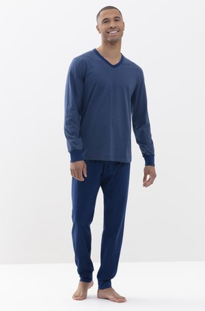 Navy striped long-sleeve V-neck top with ribbed cuffs, paired with solid navy pants. Soft fabric, relaxed fit, worn barefoot.